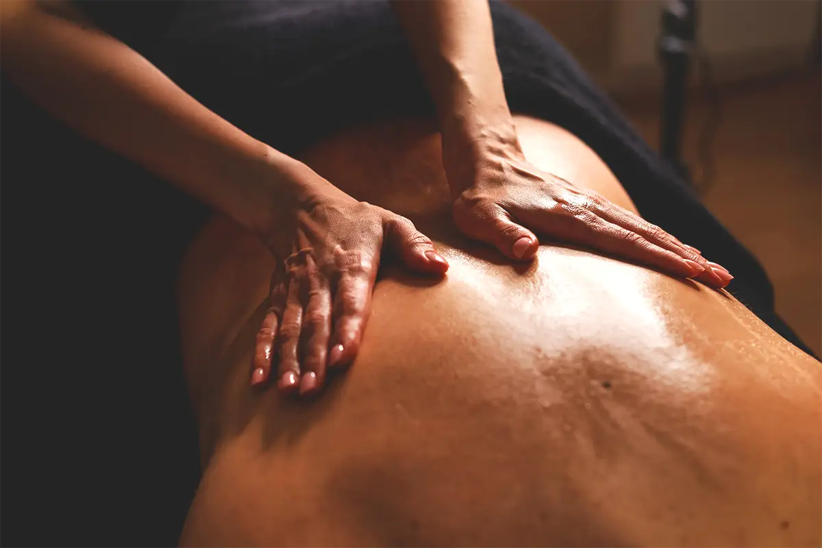 Essential oil slowly being massaged on a client's back.