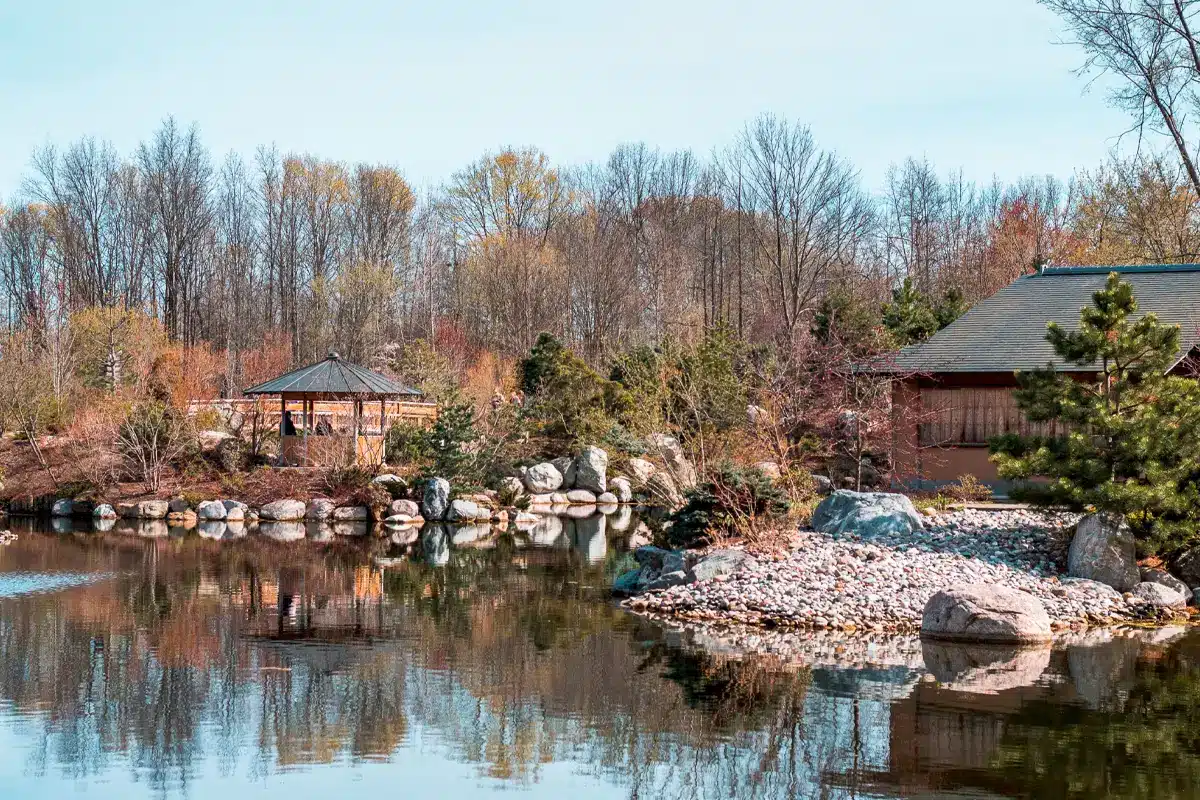 View of cabins and the pond in Frederik Meijer Gardens in Cascade Michigan.