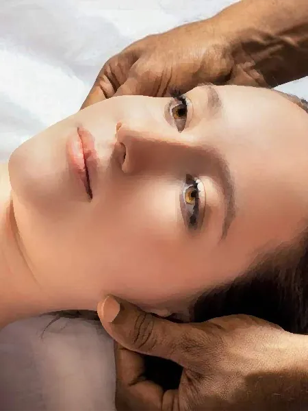 Hands slowly massaging the sides of a relaxed woman's head.