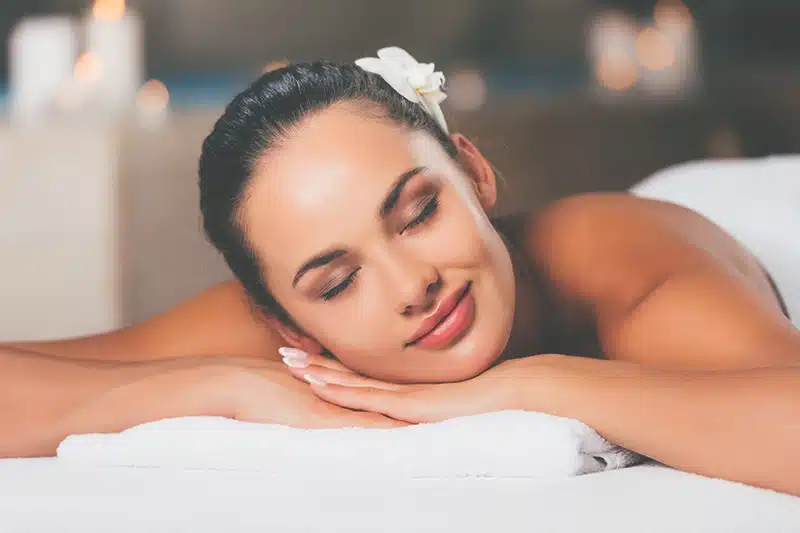Happy woman relaxing at massage salon