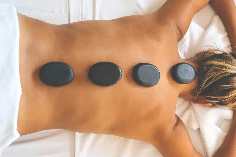 Woman relaxing with hot-stones on her back