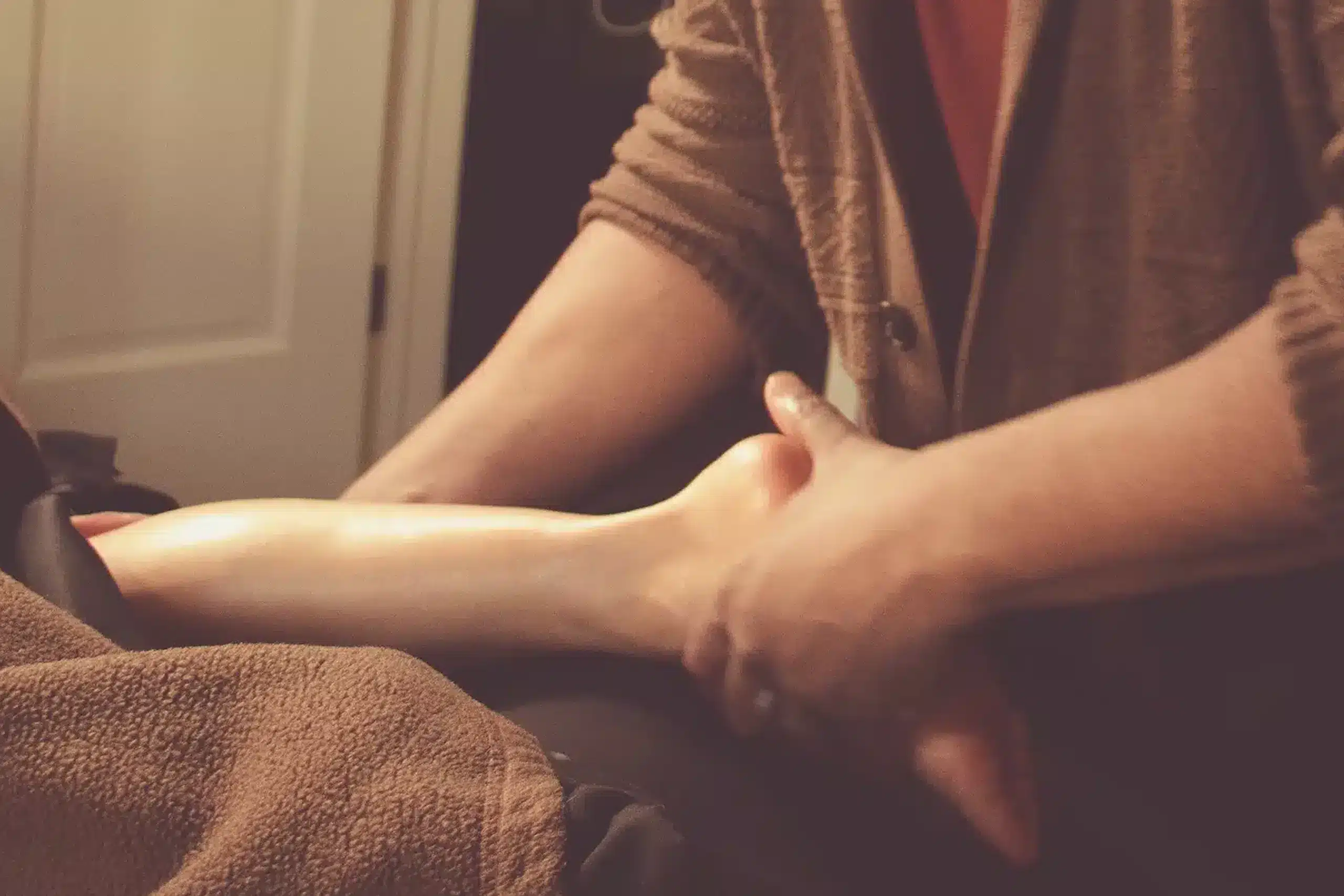 Close up of Johaun give client a foot massage.