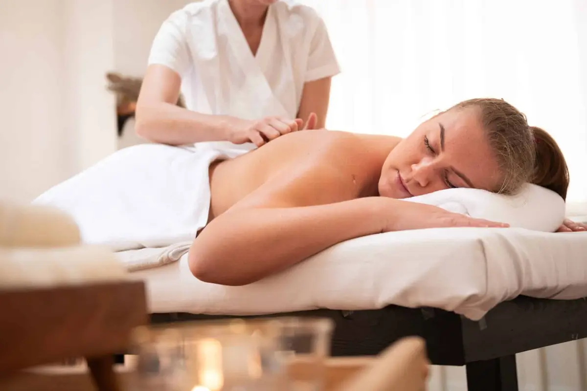 A woman getting a relaxing massage in the comfort of her own home.