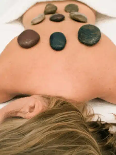 A relaxed woman with hot stones on her back