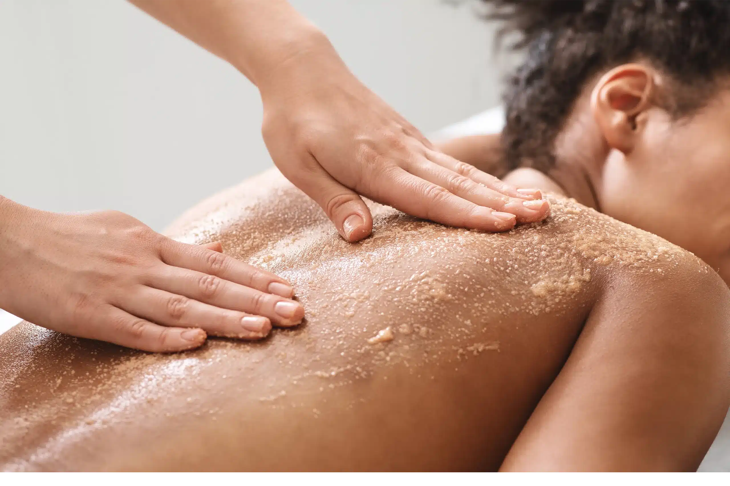 Two jars of exfoliating sugar cubes, one peach scented and one dream scented.