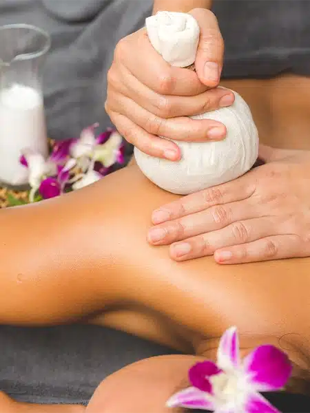 A relaxed woman with hot stones on her back