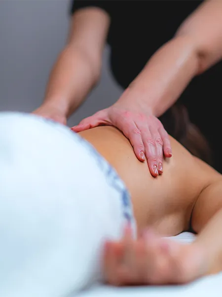 Relaxation with a traditional Lomi Lomi Hawaiian back massage at a wellness center.
