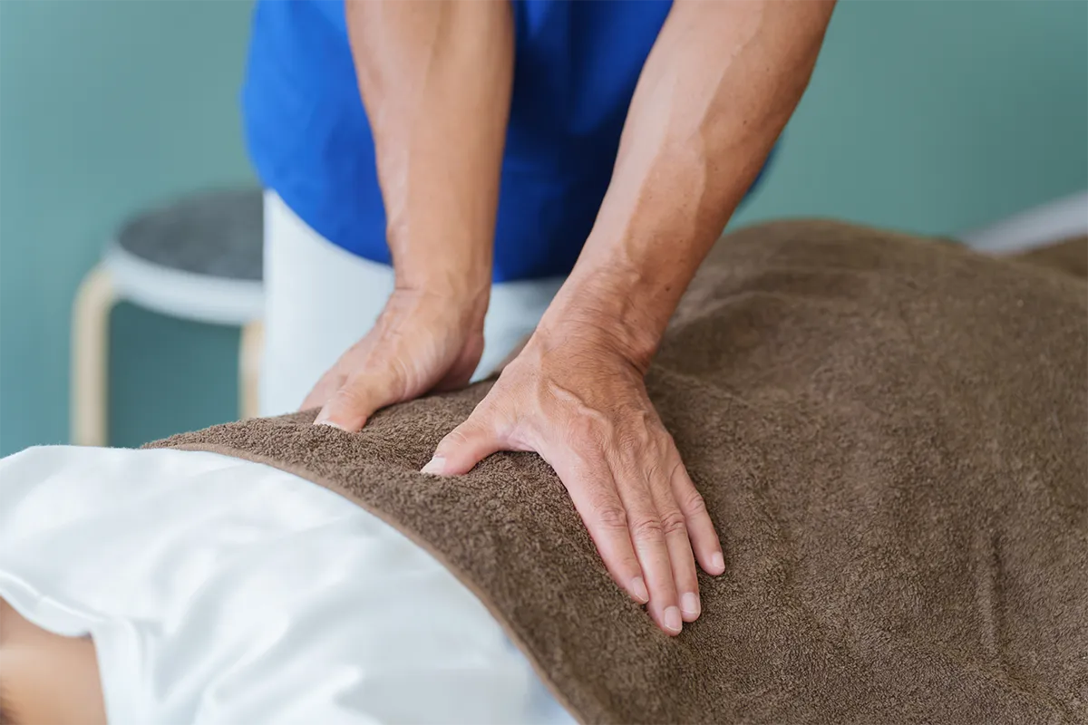 Woman relaxing with hot-stones on her back