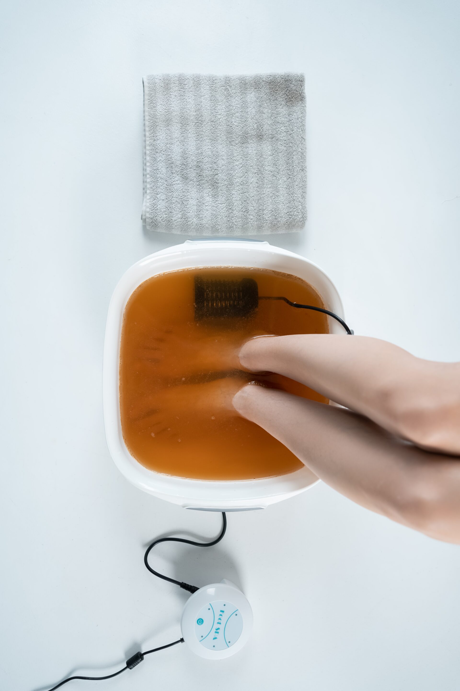 Procedure of ionic detox foot bath machine in spa beauty center isolated.