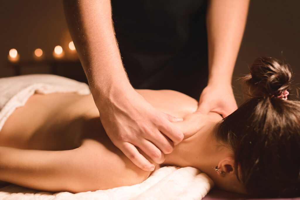 Massage therapist performing recovery-focused bodywork to reduce muscle tension and improve overnight sleep recovery.